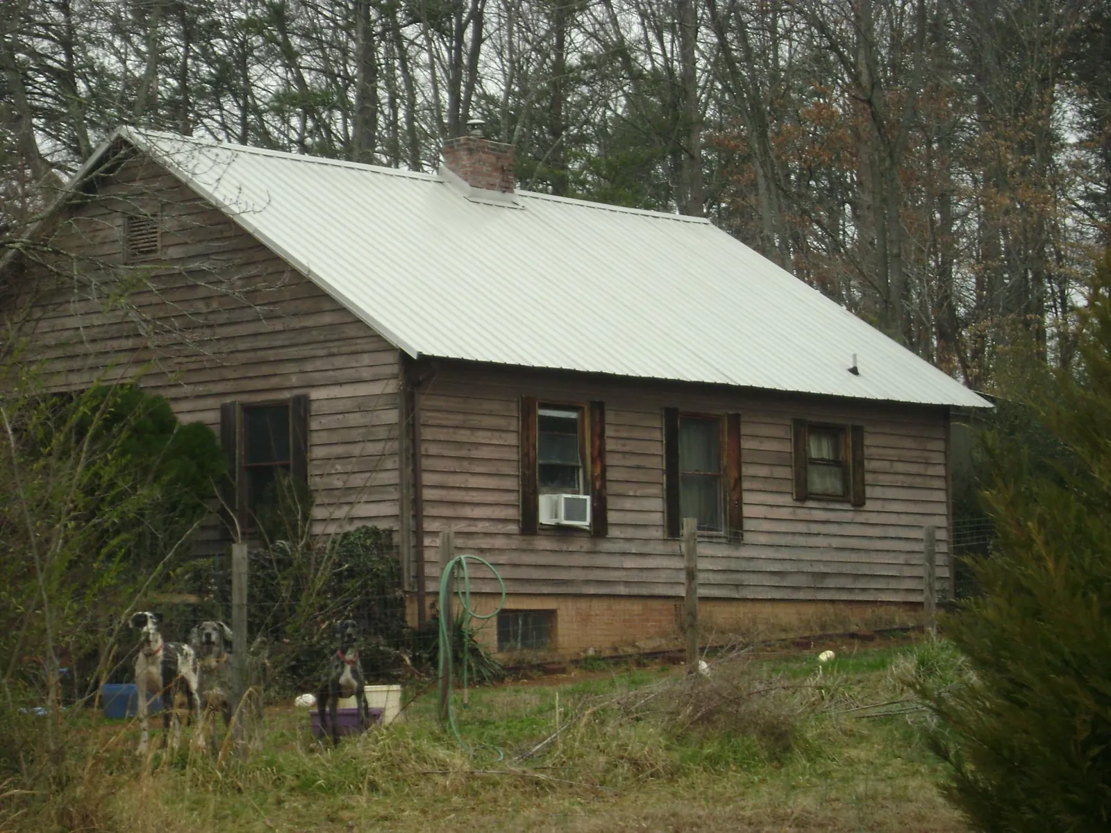 White metal roof on an old wood sided farmhouse, from a Asphalt Shingle Roof Repair job in Modena